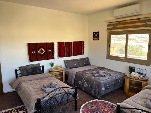 a living room with two beds and a couch at Eman house in Wadi Musa