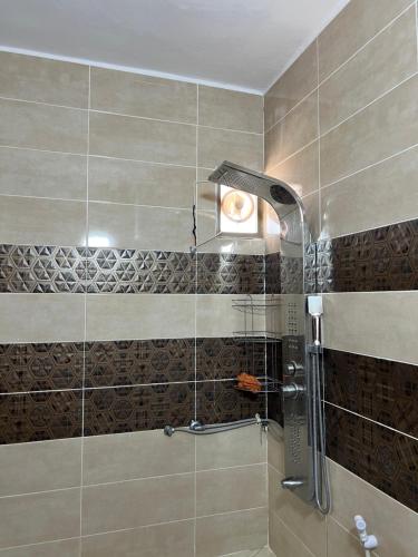 a shower with a glass door in a bathroom at Eman house in Wadi Musa