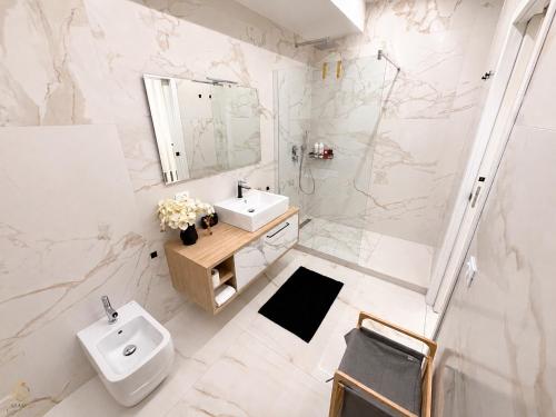 a bathroom with a sink and a toilet and a shower at CasaKadd Grand Escape in Civé
