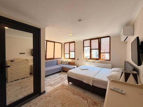 a bedroom with a bed and a blue couch at Çakır Residence in Trabzon