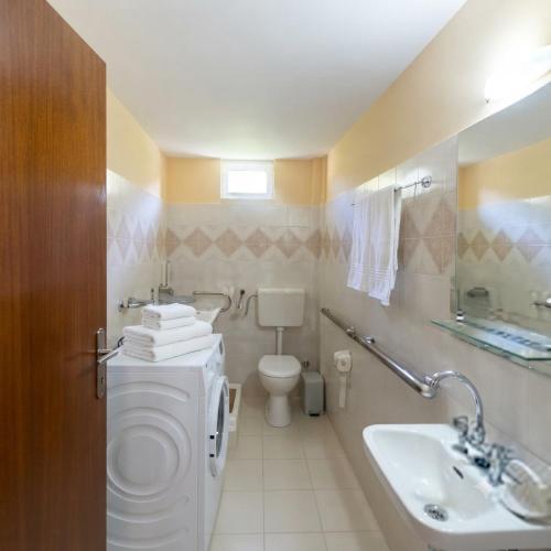 a bathroom with a toilet and a sink at Stefanos house in Parga