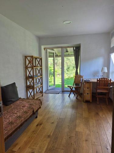 a bedroom with a bed and a desk and a table at River Side Studio, 9mi from Palanga, With sauna in Kretinga