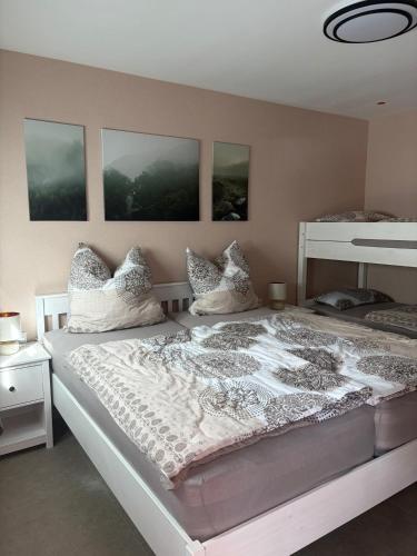 a bedroom with a large white bed with pillows at Ferienwohnung Am Schlagbaum in Kaltennordheim