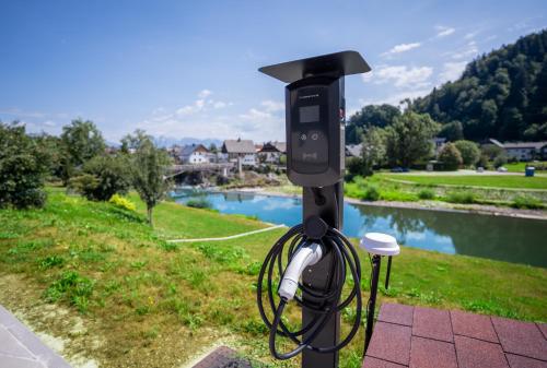 a solar powered camera on a pole next to a river at Sten House in Škofja Loka