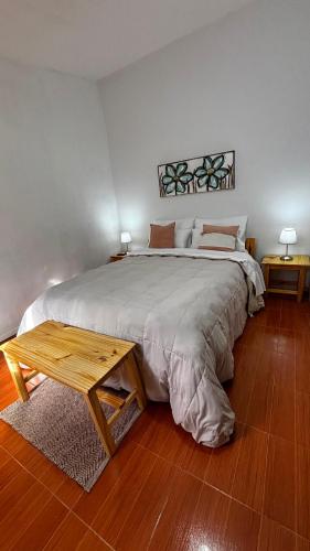 a bedroom with a large bed and a table at El rincón in Merlo