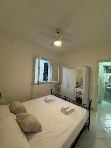 a bedroom with a bed with two towels on it at Salento Holiday Home in Torre Inserraglio