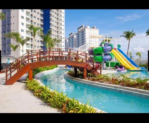 a bridge over a water park with a slide at Beach Gav Resort in Ilha de Atalaia
