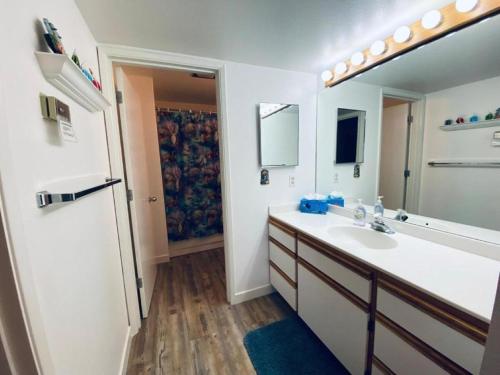 a bathroom with a sink and a large mirror at #13 Condo near large pool-Gorge shuttle-book separately in Quincy