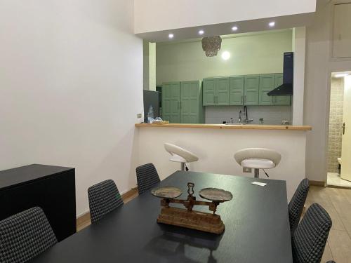 a conference room with a table and chairs and a kitchen at Beit Rifi Mountain Escape, with intex pool, Feitroun in Al ‘Aqabah