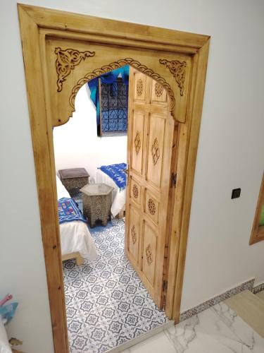 an open door into a room with a bedroom at FATI GUEST HOUSe in Chefchaouen