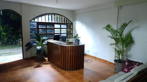an office with a reception desk and potted plants at Montañita Lodge in La Merced