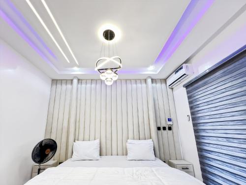 a bedroom with a bed and a ceiling at Domina Serviced Apartment in Kubwa