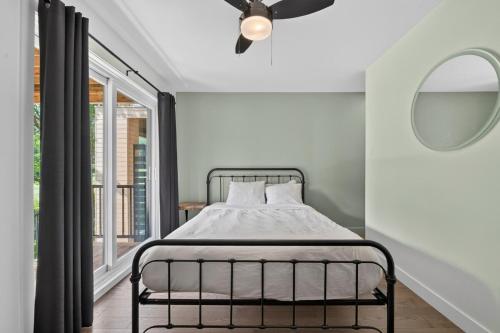 a bed in a room with a window and a ceiling fan at Unit 178 - 4 bedrooms - Sleeps 8 in Beaupré