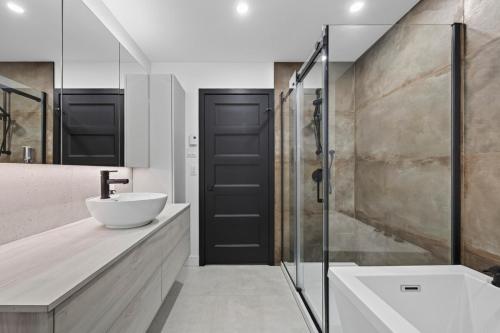 a bathroom with a sink and a glass door at Unit 178 - 4 bedrooms - Sleeps 8 in Beaupré