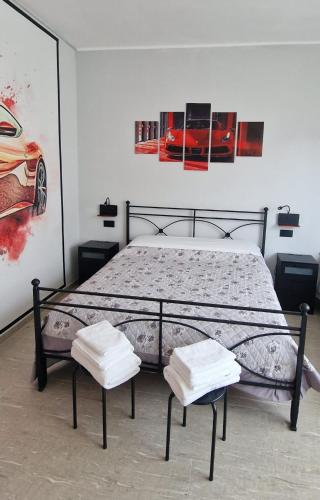 a bedroom with a bed with two chairs in it at Damhomeitaly in Modena
