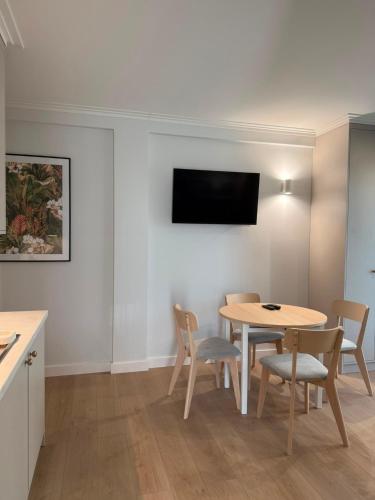 a dining room with a table and chairs and a tv at Port Rewa in Rewa