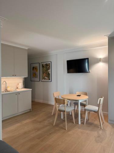 a kitchen and dining room with a table and chairs at Port Rewa in Rewa