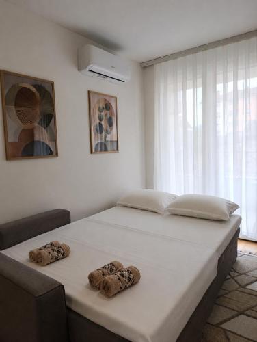 a bed in a room with two towels on it at Apartman Vida in Novi Pazar
