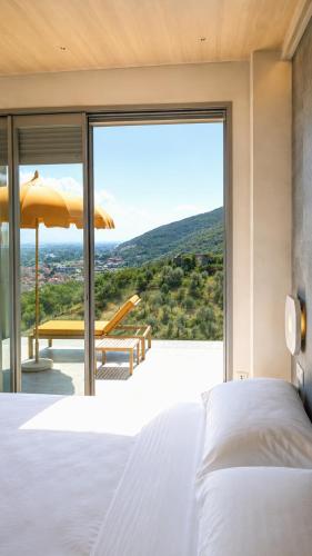 a bedroom with a bed and a large window at Le Stele Hotel in Lerici