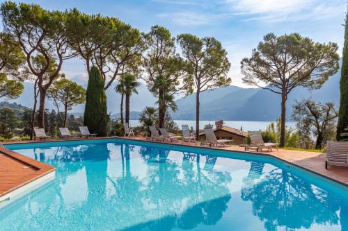 a swimming pool with a view of the mountains at Brentano Giardino in Mezzegra