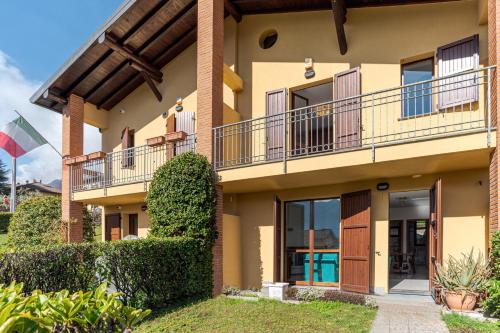 an apartment building with balconies and bushes at Lenno Glamour in Lenno