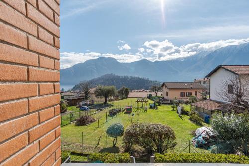 two pictures of a village with mountains in the background at Lenno Glamour in Lenno