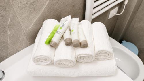 a pile of white towels sitting on top of a sink at Venice Easy Stay Meolo in Meolo