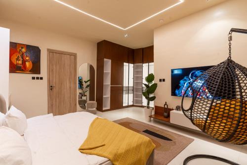 a bedroom with a bed and a large screen tv at Luxe Haven in Lekki