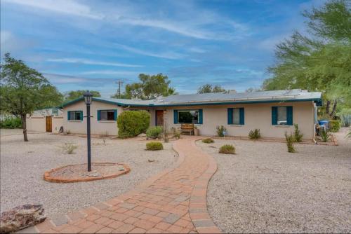 a house with a brick driveway in front of it at Private Tucson Oasis with Pool & Large Backyard in Tucson