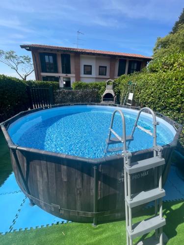 a plunge pool with a ladder in front of a house at Villetta faustina in Albairate