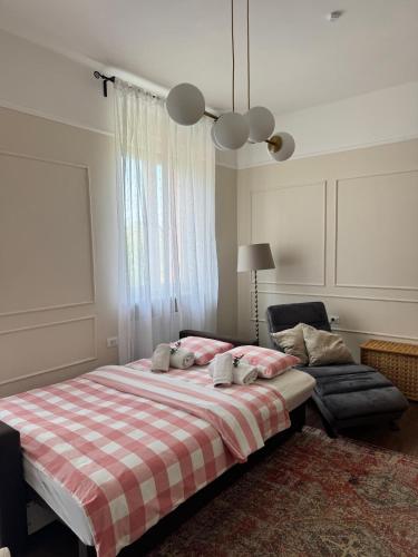 a bedroom with a large bed and a chair at Little Paradise - charming apartment in Labin