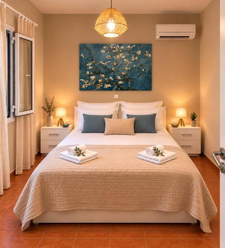 a bedroom with a large bed with two towels at Porto Vigla in Tranakatika