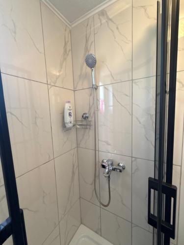 a bathroom with a shower with a shower head at Villa Kovacevic 2 in Bihać