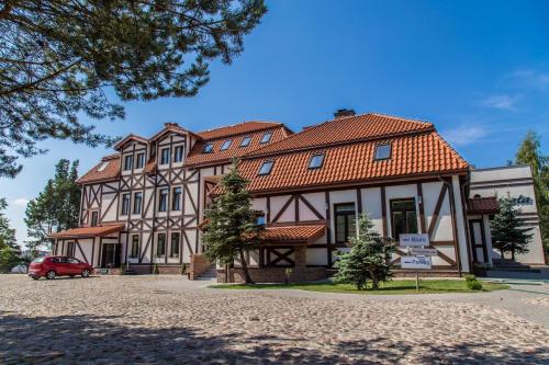 a large building with a red roof at Fregata in Ełk