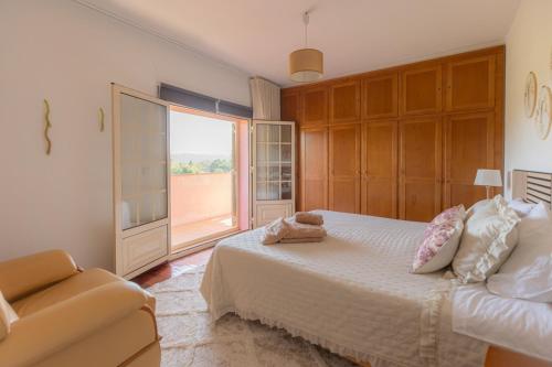 a bedroom with a bed and a window and a couch at Casa da Cesta in Celorico de Basto