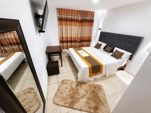 a hotel room with two beds and a window at Hotel World Peru in Lima