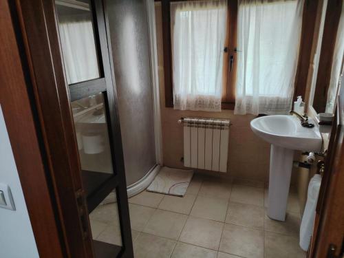 a small bathroom with a sink and a shower at Cristeta2 in Medina de Pomar