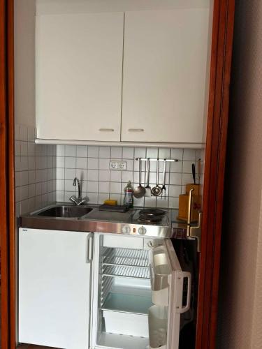 a small kitchen with a sink and a stove at Ferienwohnung Hunsrückblick in Thalfang