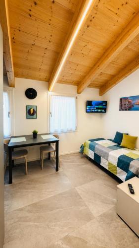 a bedroom with a bed and a desk in a room at Venice Easy Stay Meolo in Meolo