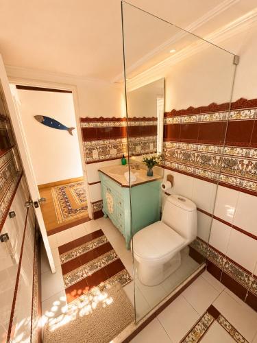 a bathroom with a toilet and a sink at Hotel Isla Azul - Islas del Rosario in Isla Grande
