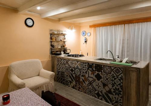 a kitchen with a counter with a sink and a chair at Vintage 4BR Borjomi Hideaway in Borjomi