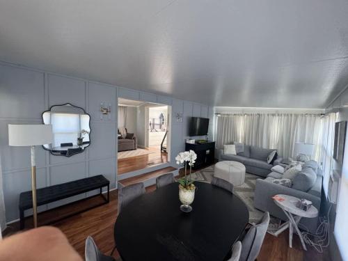 a living room with a table and a couch at Sherkston Shores Cottage in Port Colborne