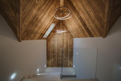 a room with a wooden ceiling and stairs with a glass floor at Stacja Tatry in Poronin