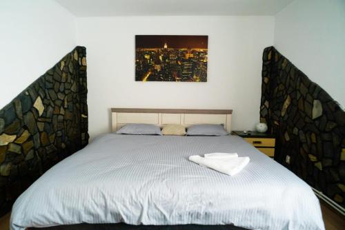 a bedroom with a bed with a large bed frame at Elite Apartament Hunedoara in Hunedoara