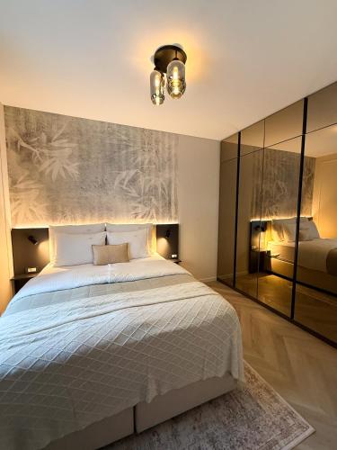 a bedroom with a large bed and a painting on the wall at Kalan Boutique Stay in Žirovnica