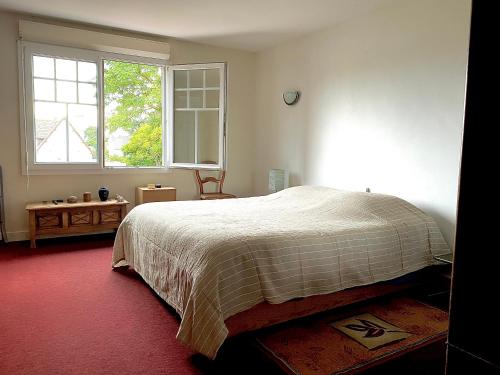 a bedroom with a large bed and a window at Mathéro in Saint-Pair-sur-Mer
