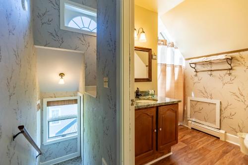 a bathroom with a sink and a window at Sylvan Inn Bed & Breakfast in Glen Arbor