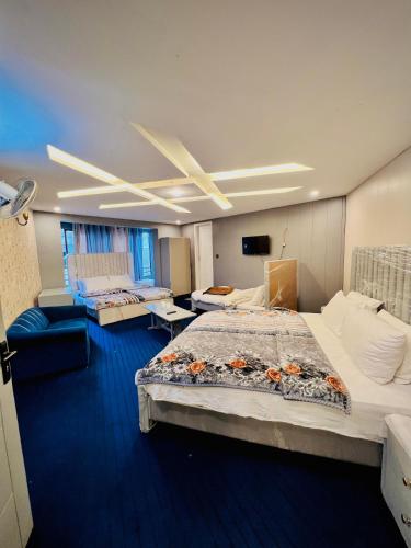 a large room with two beds and a ceiling at Mall Rd Murree Ciros Hotel in Murree