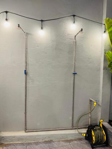 a white wall with two lights on it at N&N Family in Ngân Hà