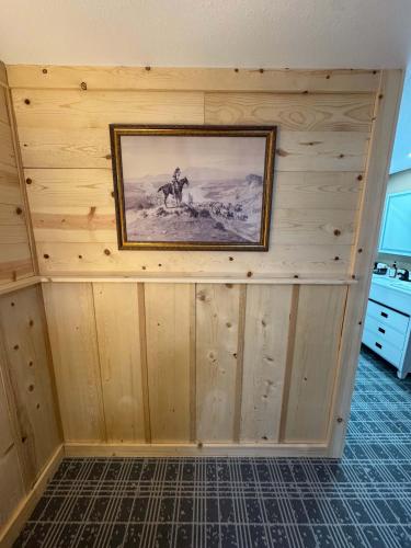 a room with a painting on a wooden wall at Suite 102 in Lusk